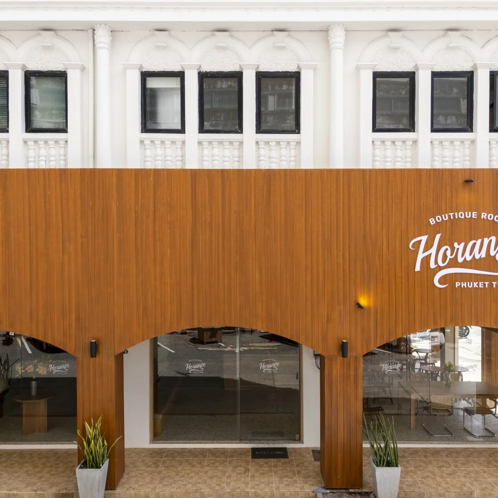 The amber arched colonnade running along the front of Horange Phuket Town
