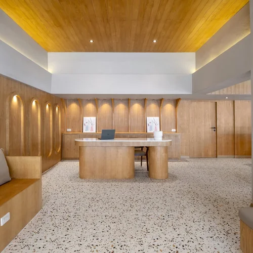 Lobby of Horange Phuket Town with terrazzo floors and an oak reception desk