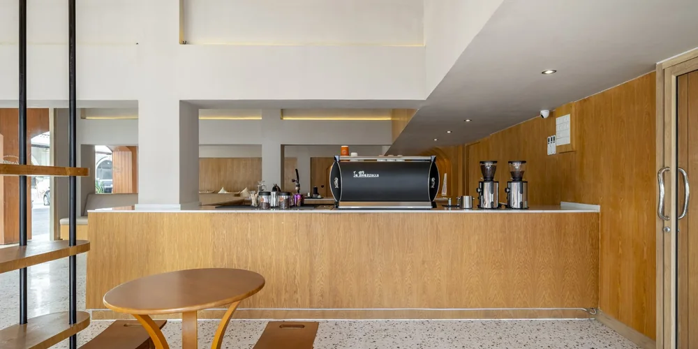 The espresso bar at Horange Phuket Town, with a La Marzocco machine on a timber counter