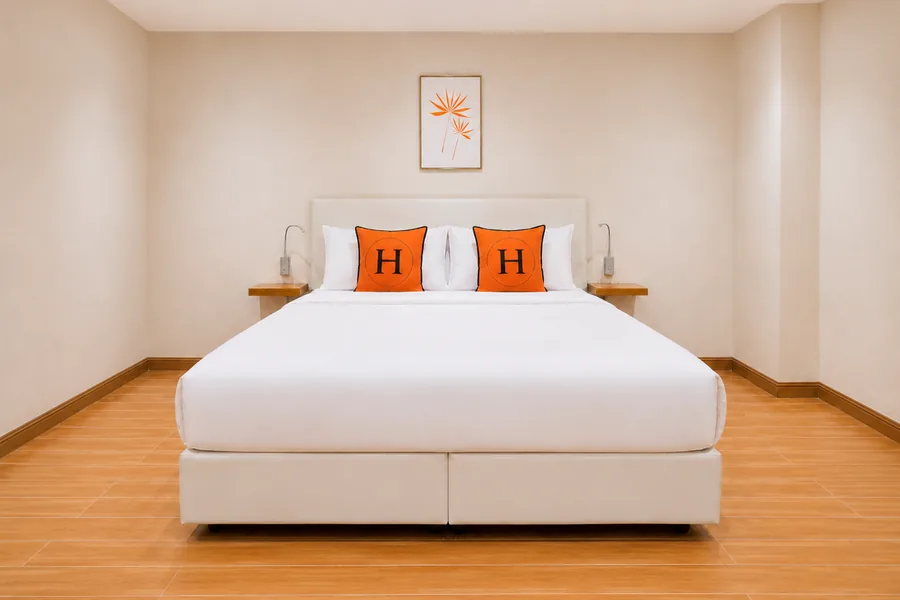 Deluxe room at Horange Phuket Town with white walls and wall-mounted reading lights